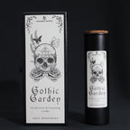 Gothic Garden candle packaging with skull and floral design on a black background