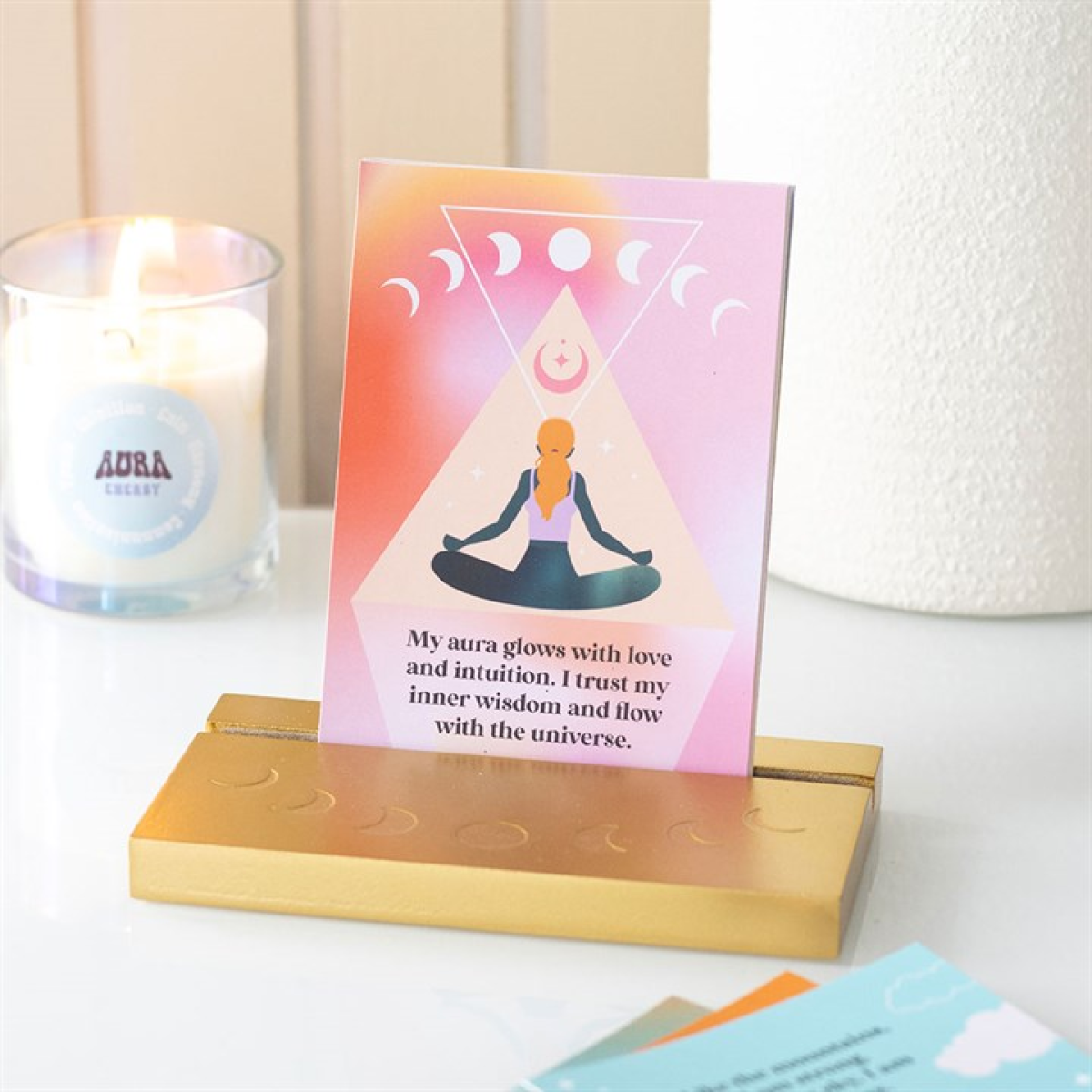 Card with a silhouette of a person in meditation on a stand next to a candle