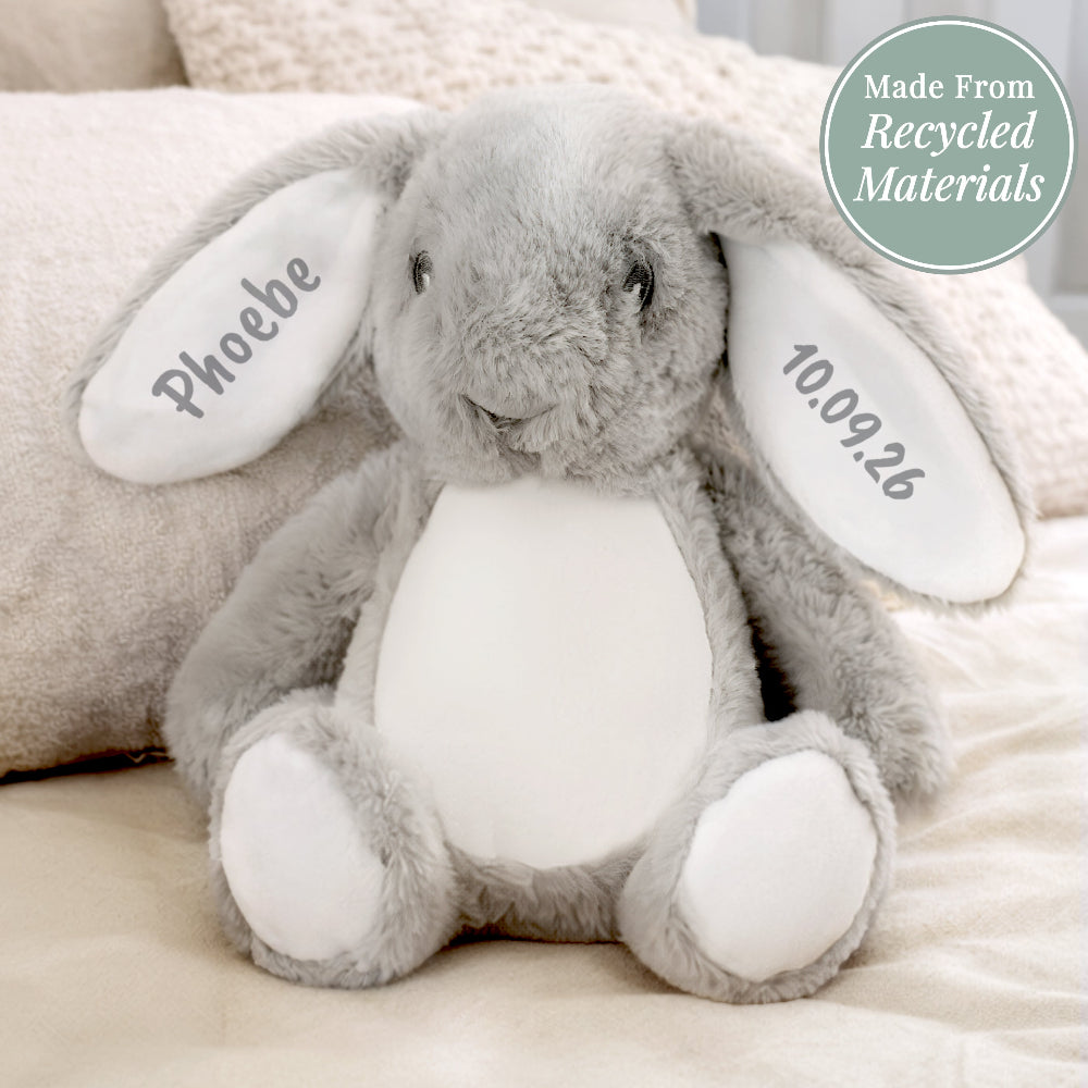 Gray plush bunny with 'Phoebe' and '10.09.26' on ears, made from recycled materials.
