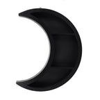 Black crescent moon-shaped shelf on a white background
