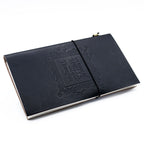 Black leather notebook with embossed design on a white background