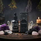 Black bottle and box of 'Cursed' perfume oil on a white background
