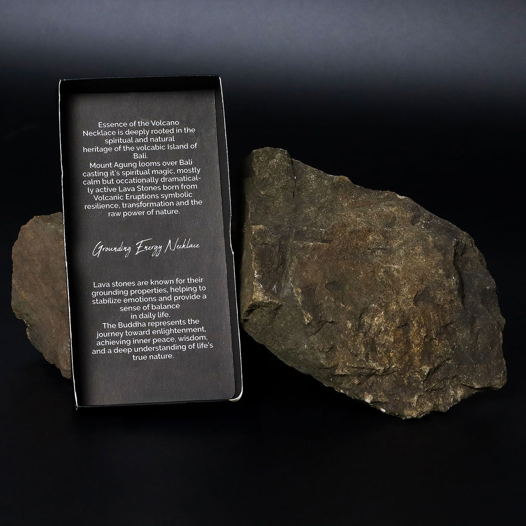 Rock with a black card displaying text next to it on a dark background
