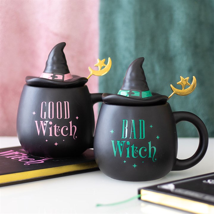 Two black mugs with witch hats and text, one labeled 'Good Witch' and the other 'Bad Witch', on a white surface.