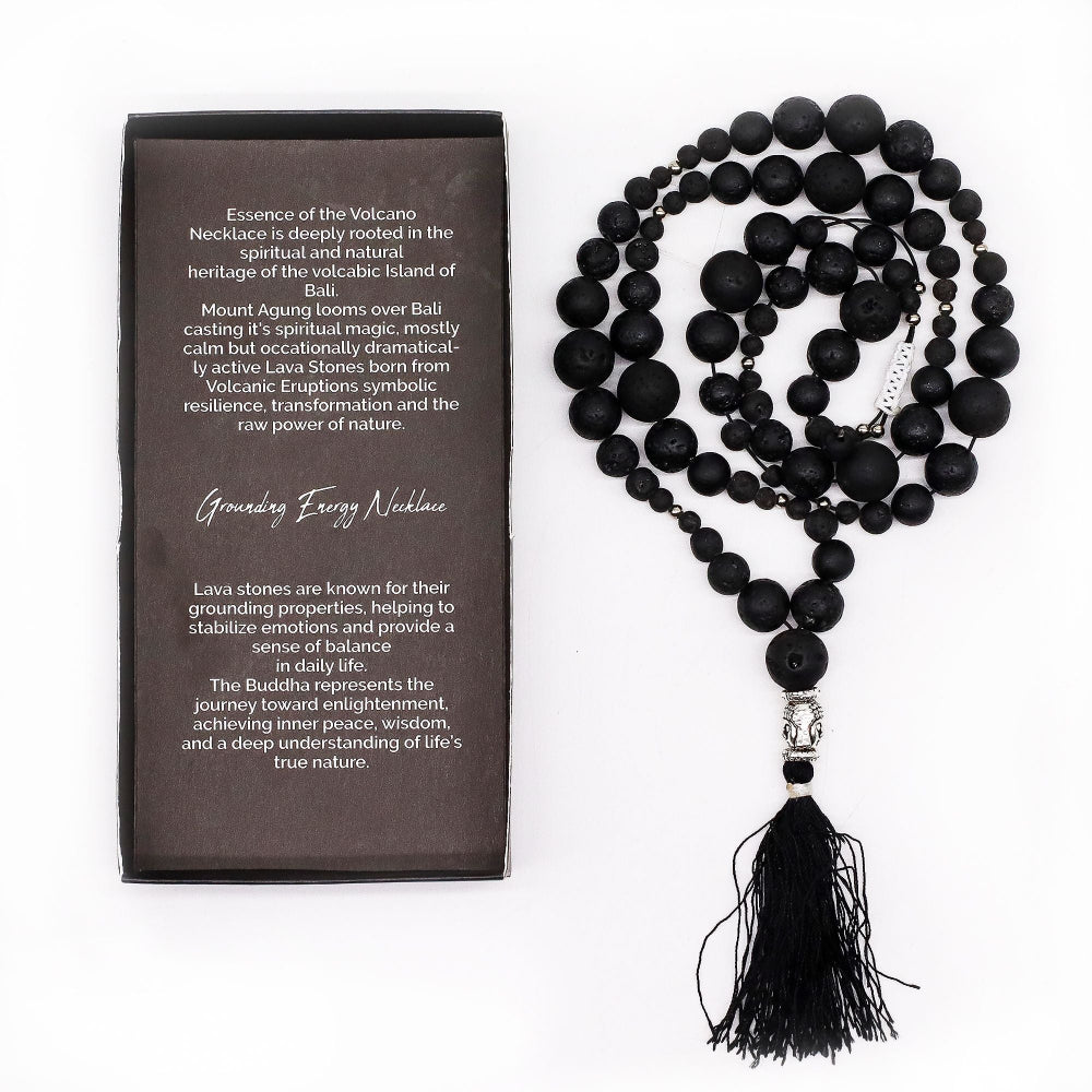 Black beaded necklace with tassel on a white background