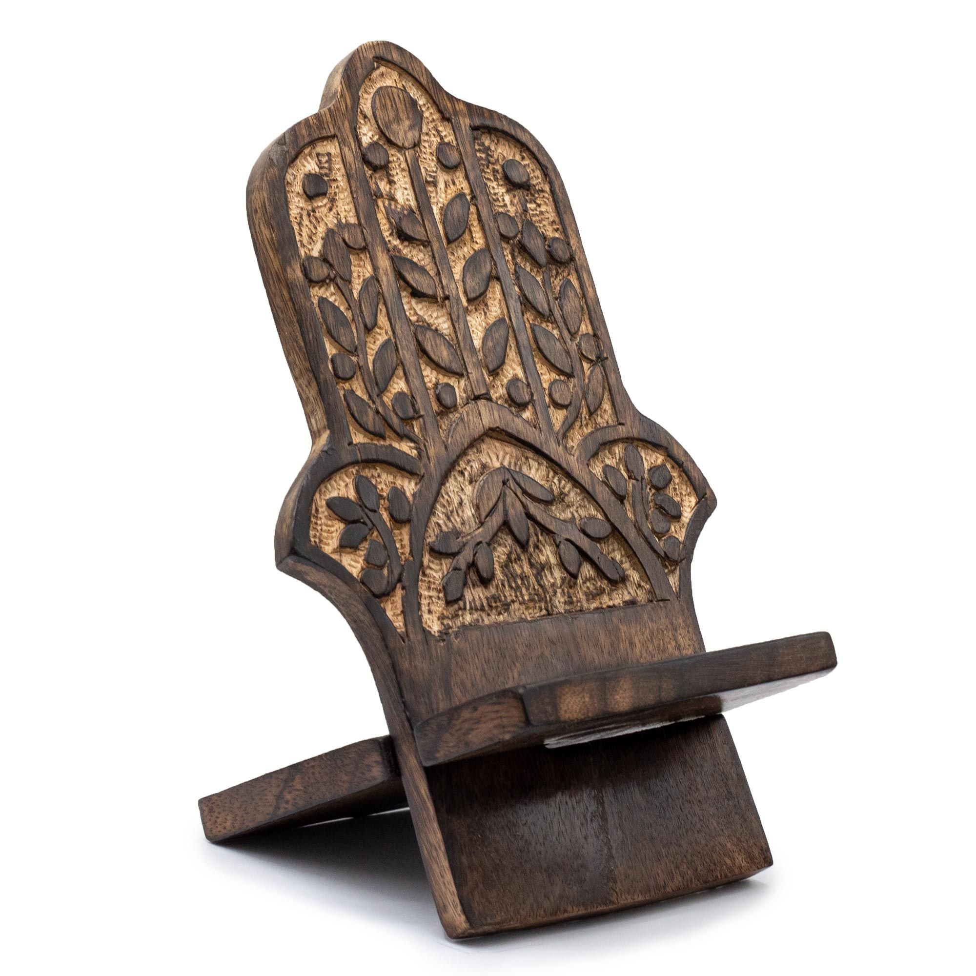 Wooden phone stand with intricate carvings on a white background