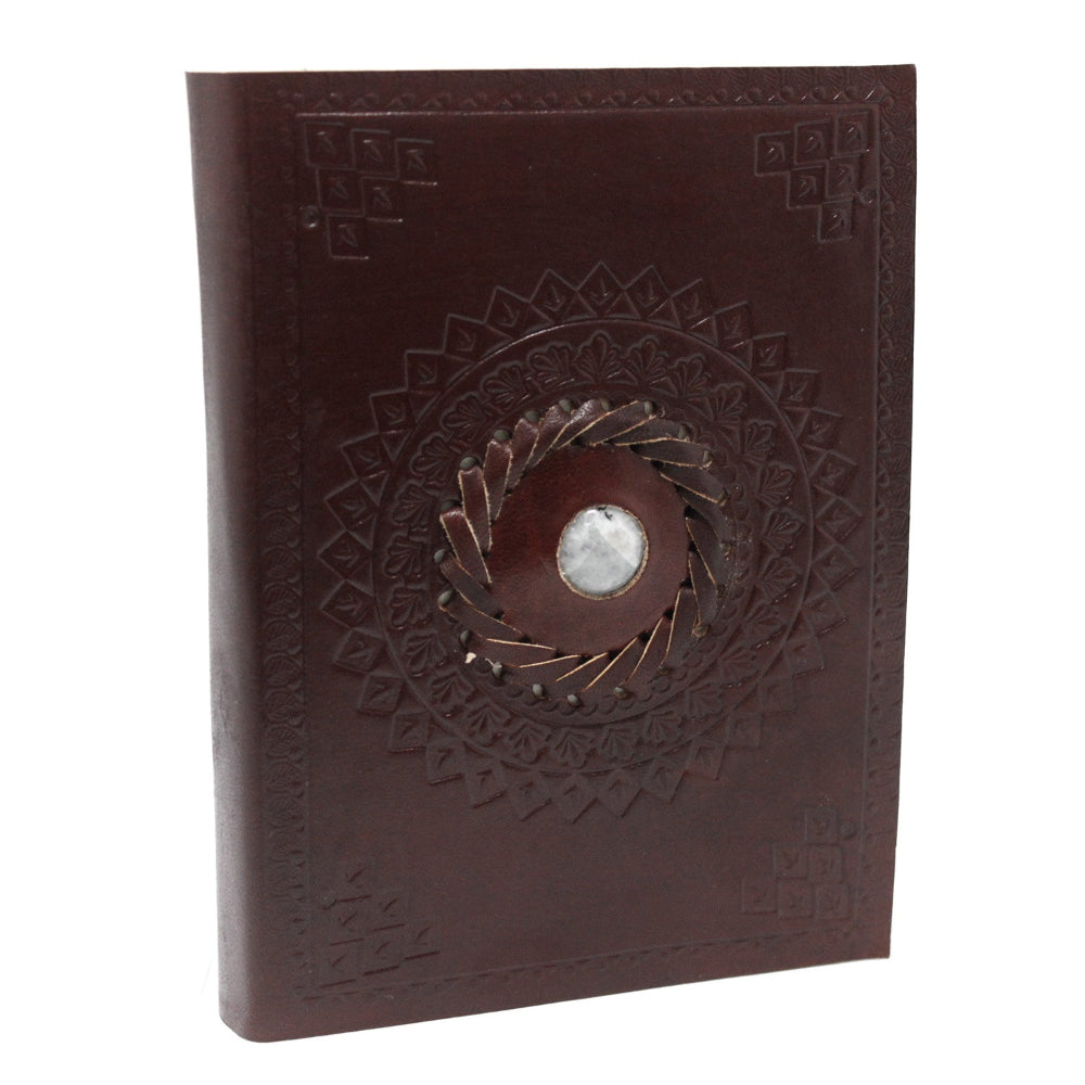 Brown leather notebook with embossed design and central button on a white background