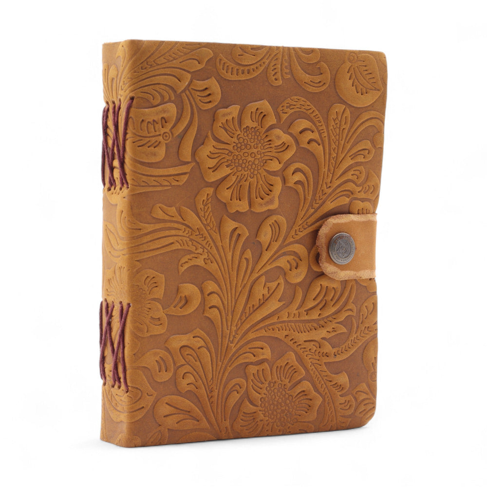 Brown leather notebook with floral embossing on a white background