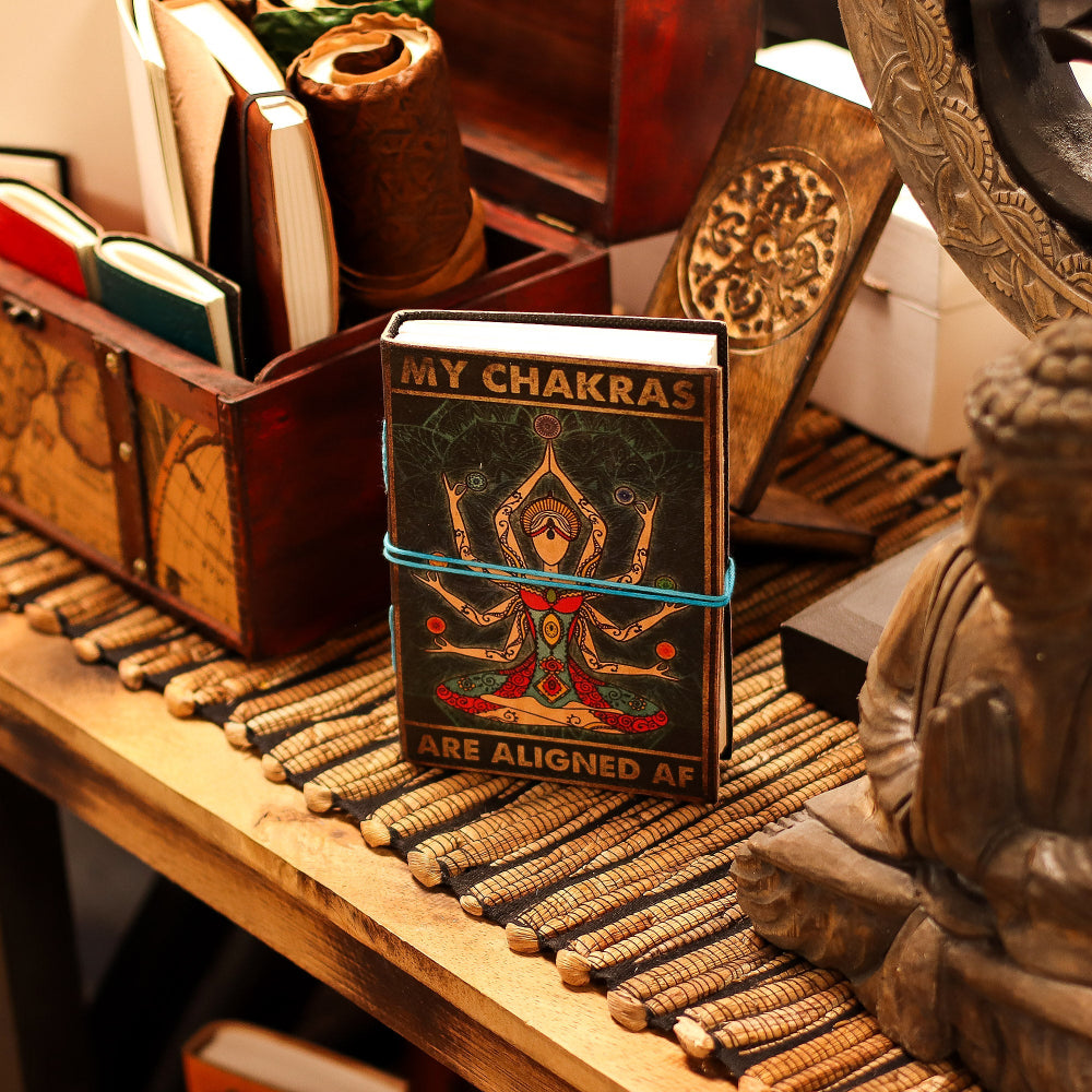 Book titled 'My Chakras' on a wooden surface with decorative items