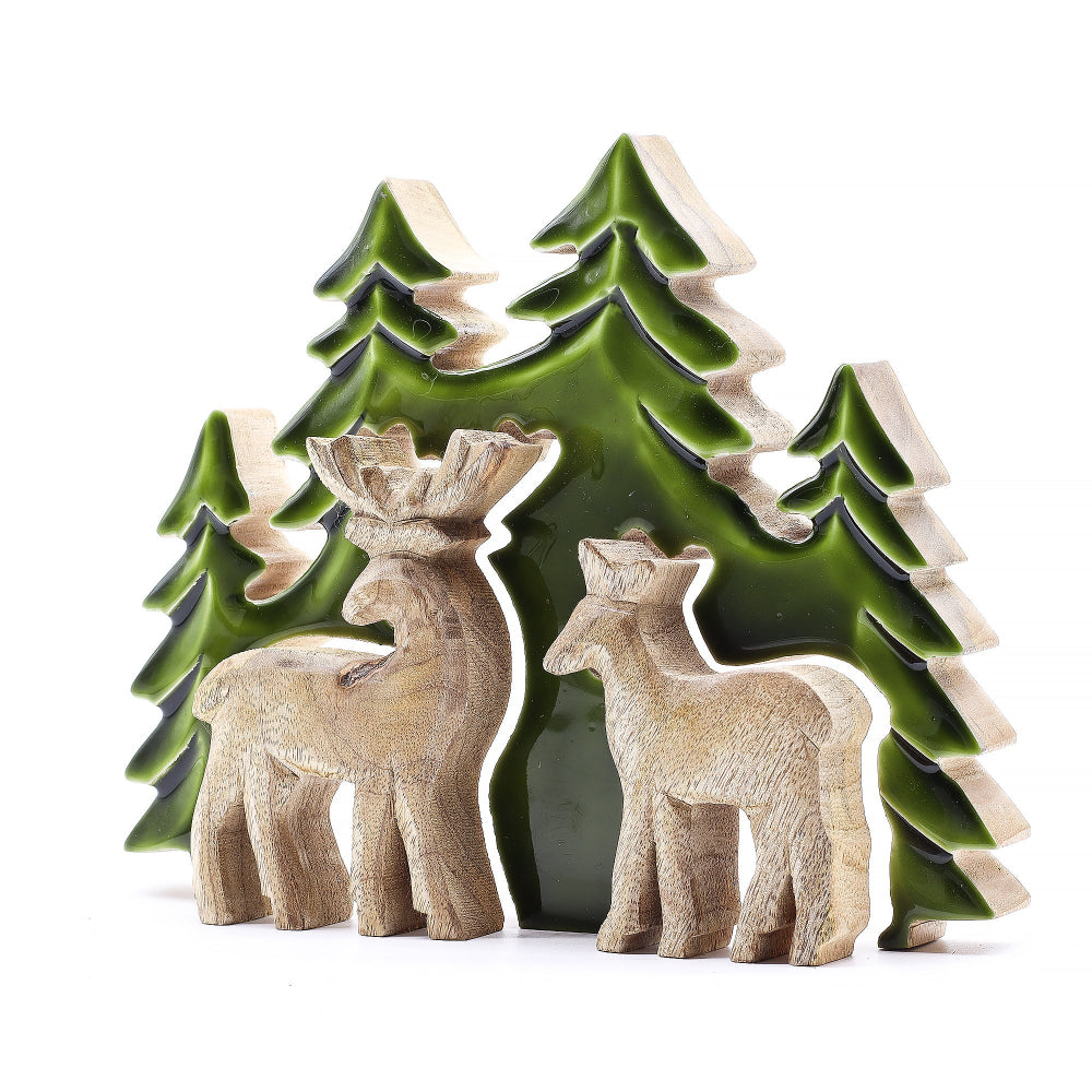 Decorative ceramic reindeer and trees on a white background
