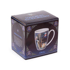 Mug in a decorative box with intricate designs and text.