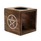 Wooden cube with pentagram design on a white background