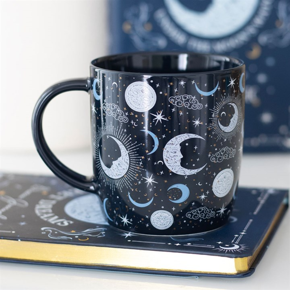 mug with celestial design on a matching coaster and book