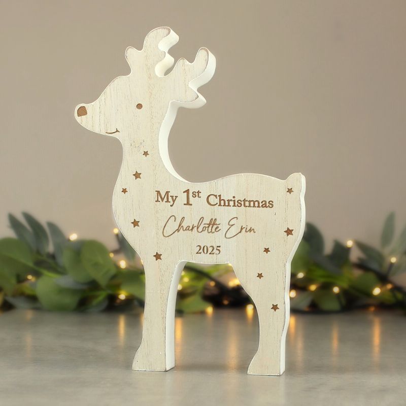 Wooden reindeer ornament with 'My 1st Christmas' engraving on a neutral background