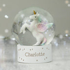 Unicorn figurine inside a snow globe with 'Charlotte' on a stand