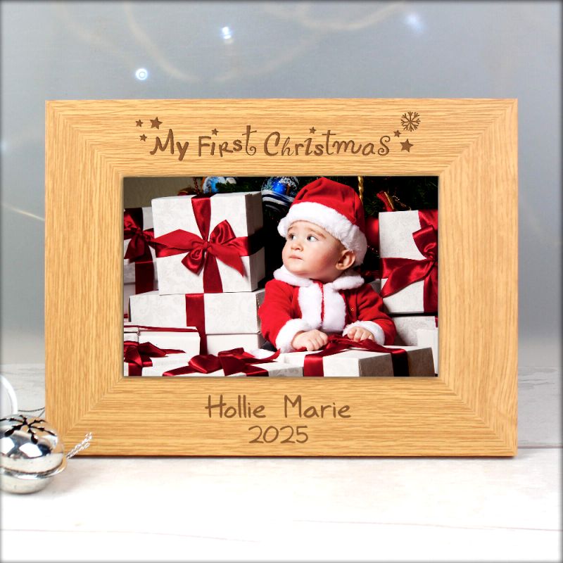 Wooden photo frame with 'My First Christmas' engraving, featuring a baby in Santa attire with presents.
