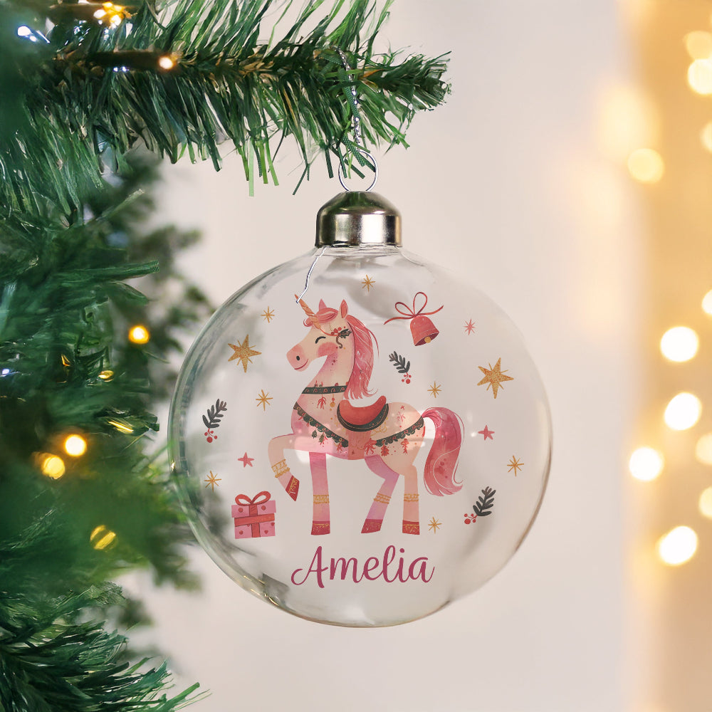Decorative Christmas ornament with a unicorn design and the name 'Amelia' on a tree.