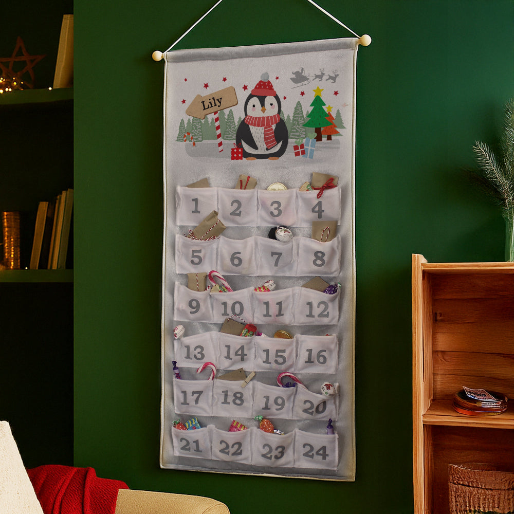 Christmas-themed Advent calendar with penguin design on a green wall.