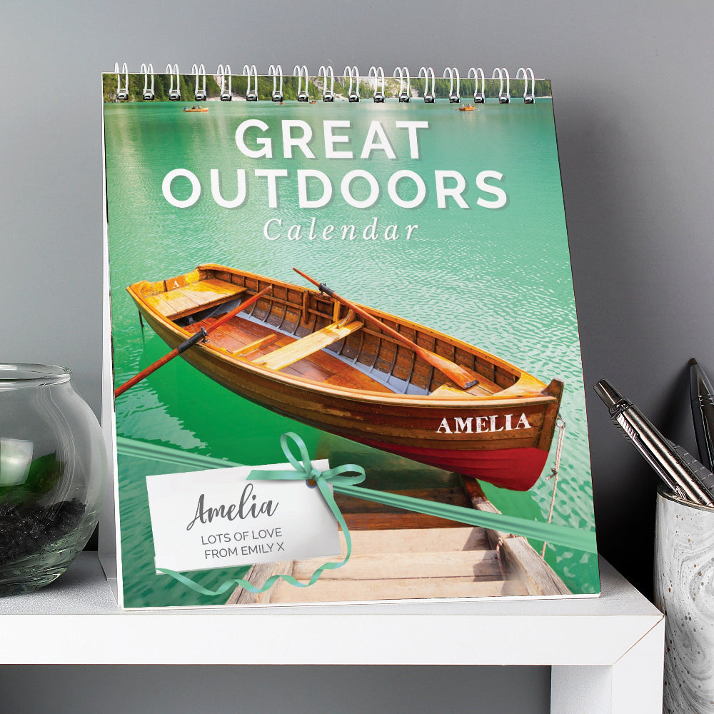 Calendar titled 'Great Outdoors' with a boat design on a gray surface