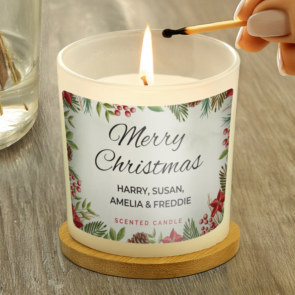Candle being lit with a 'Merry Christmas' label on a wooden surface