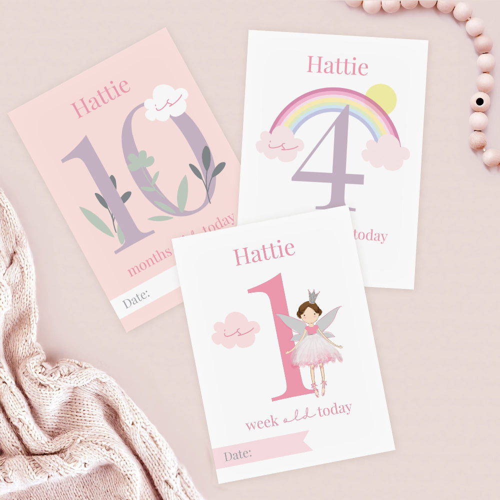 Three milestone cards for Hattie with numbers and birthday-themed designs on a light pink background.