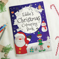 Christmas colouring book with Santa Claus and elf on a purple background, surrounded by Christmas-themed items.