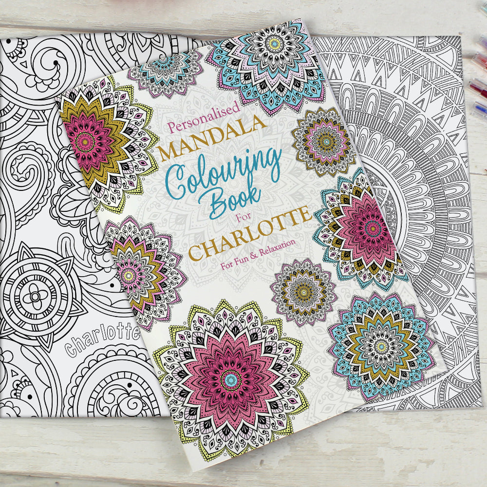 Personalized mandala coloring book with colorful designs on a wooden surface