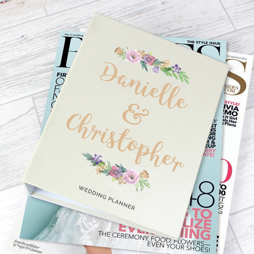 Wedding planner with personalized names on a magazine stack
