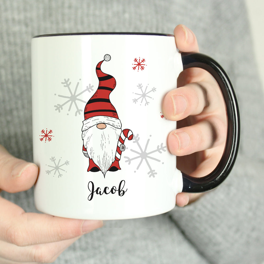 White mug with a gnome design and the name 'Jacob' held by a person.
