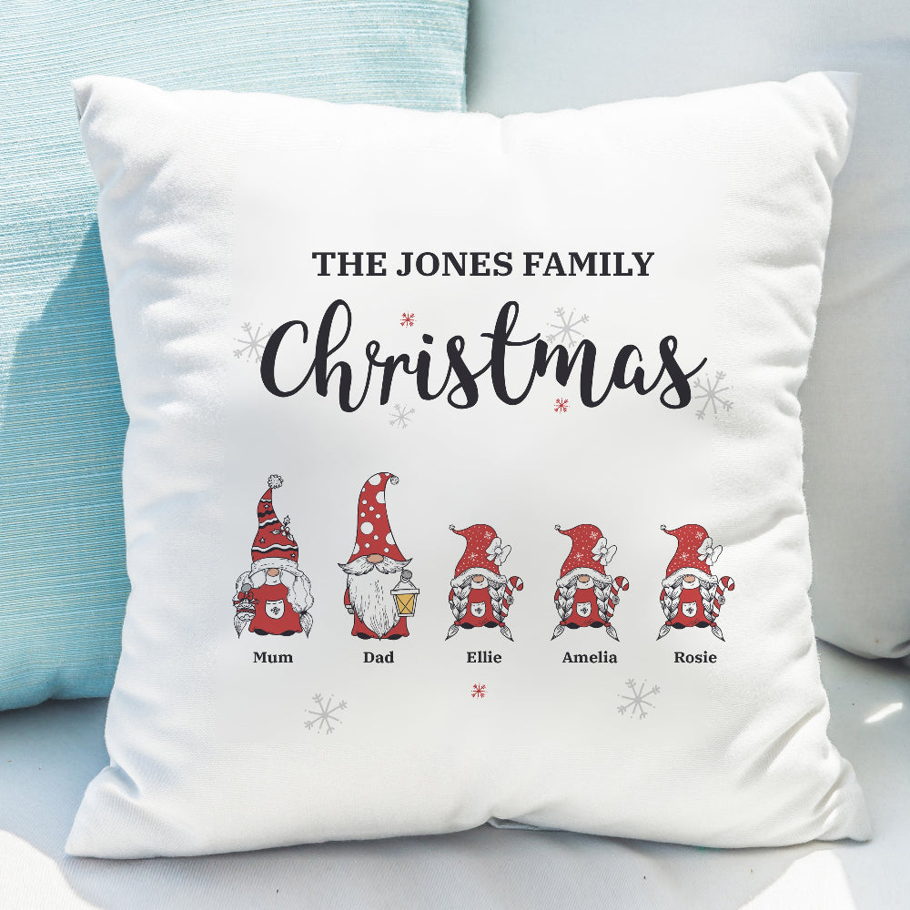Decorative pillow with family names and cartoon gnomes on a light blue background