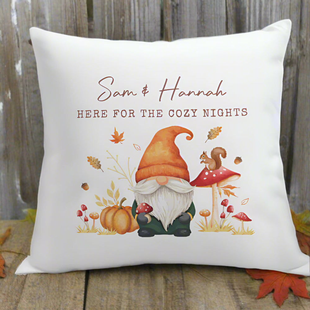 Decorative pillow with a gnome, pumpkin, and mushroom design, featuring text 'Sam & Hannah HERE FOR THE COZY NIGHTS'.
