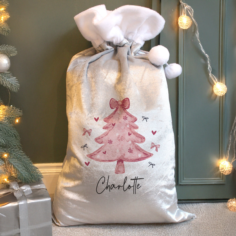 Decorative Christmas sack with a pink tree design and the name 'Charlotte' on a festive background.