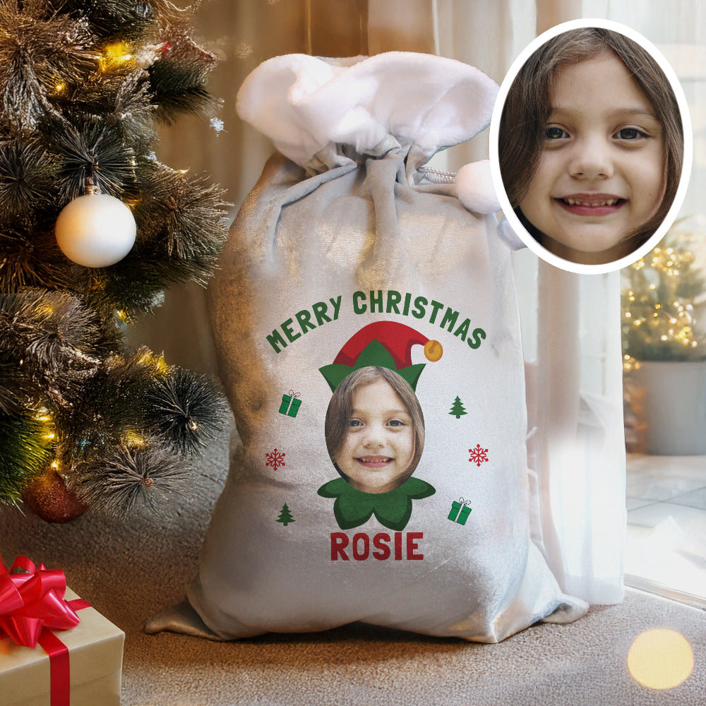 Personalized Christmas sack with a child's photo and name, surrounded by festive decorations.