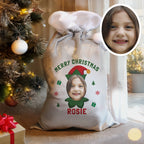 Personalized Christmas sack with a child's photo and name, surrounded by festive decorations.
