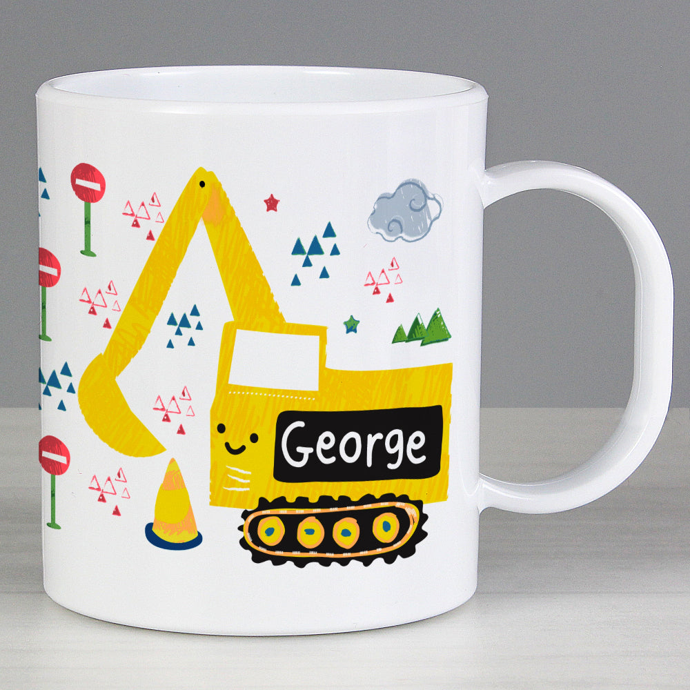 White mug with a yellow excavator design and the name 'George' on a gray background