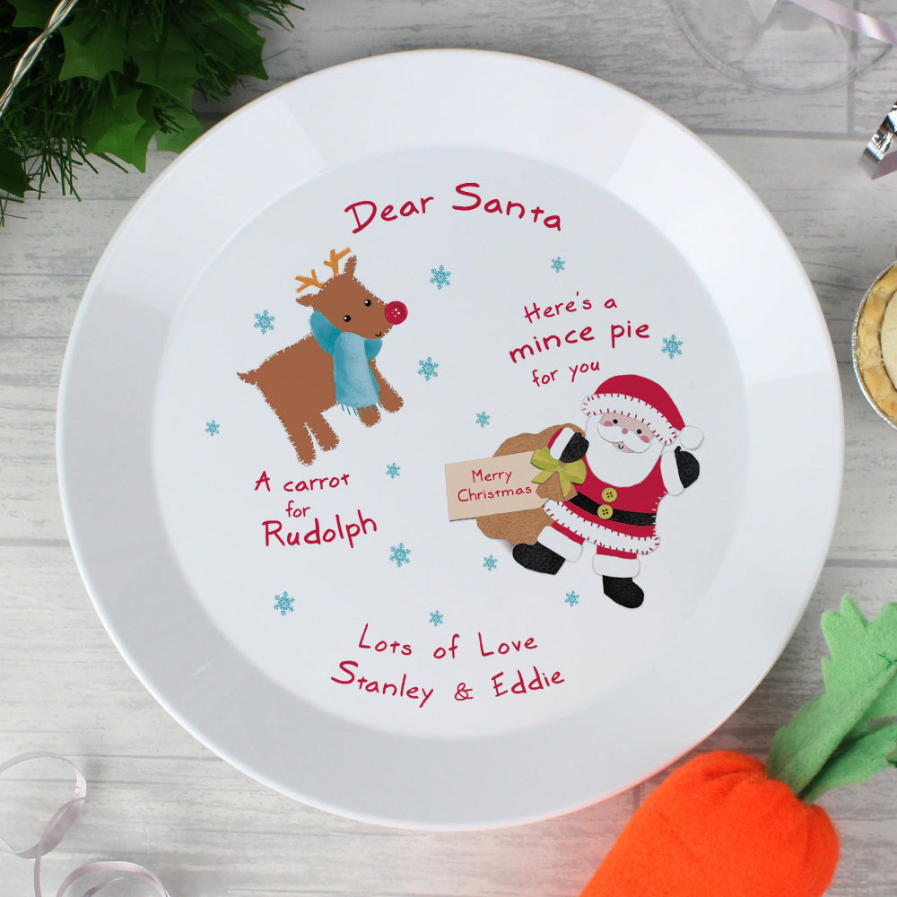 Christmas-themed plate with Santa, reindeer, and carrot design on a white background.