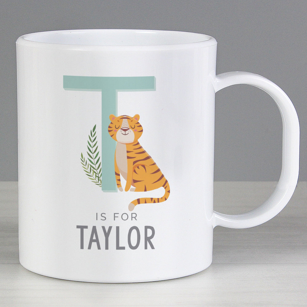 White mug with a tiger illustration and text 'T is for Taylor' on a gray background