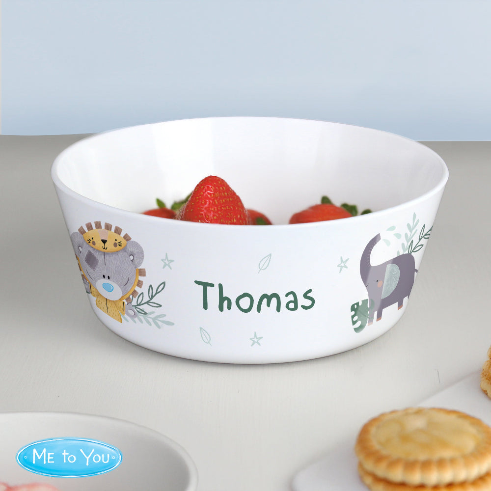 Children's bowl with animal design and name 'Thomas', containing strawberries on a light gray surface.