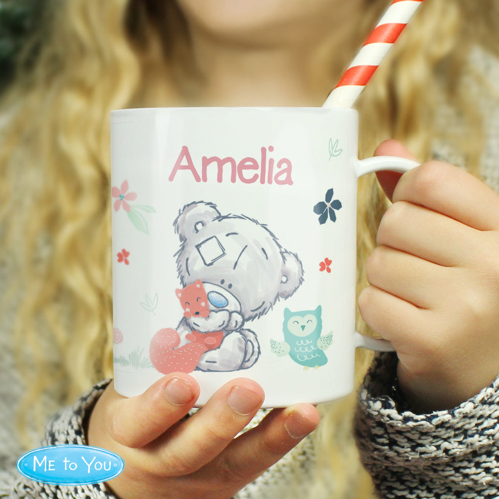 Person holding a mug with a teddy bear design and 'Amelia' printed on it, with 'Me to You' branding.