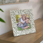 Decorative photo frame with a family photo and 'The Moore Family' text on a wooden surface.