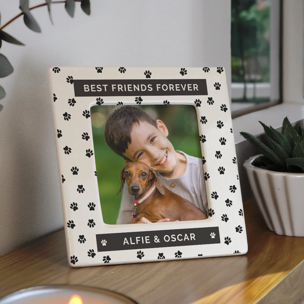 Photo frame with a picture of a boy and his dog, labeled 'Best Friends Forever', on a wooden surface.
