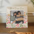 Floral photo frame with 'Best Sister Ever' text containing a photo of two women.