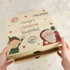 Wooden box labeled 'George's Christmas Keepakes' with festive illustrations on a light background.