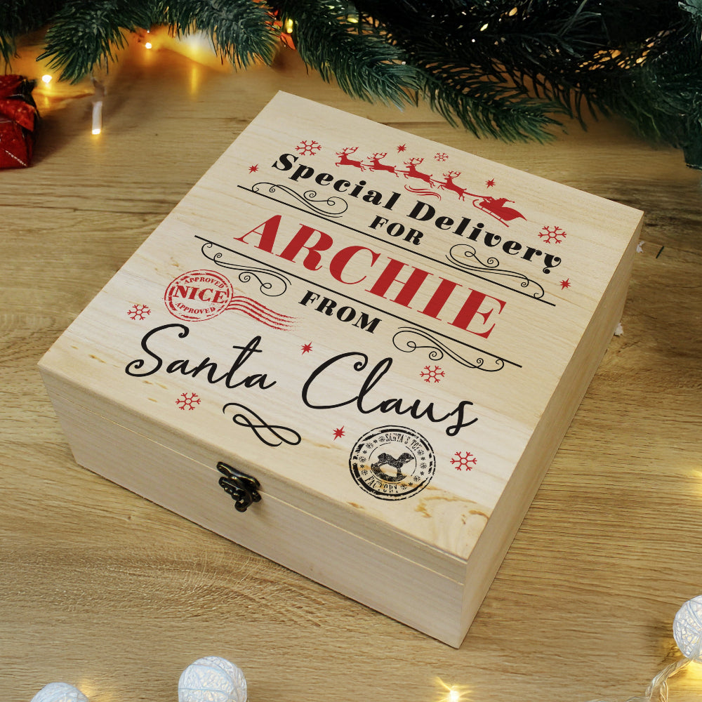 Wooden gift box with personalized text under a Christmas tree