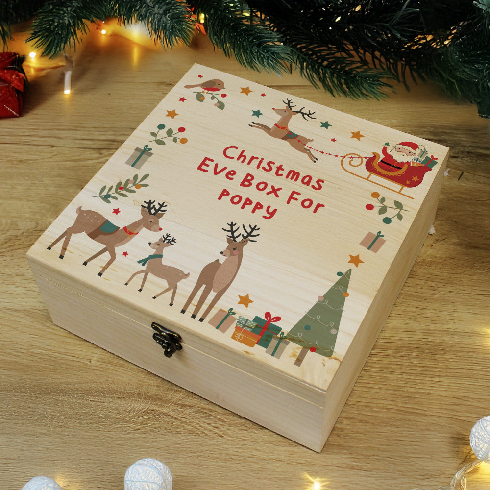 Wooden Christmas Eve box with reindeer and Santa Claus illustrations on a wooden surface.