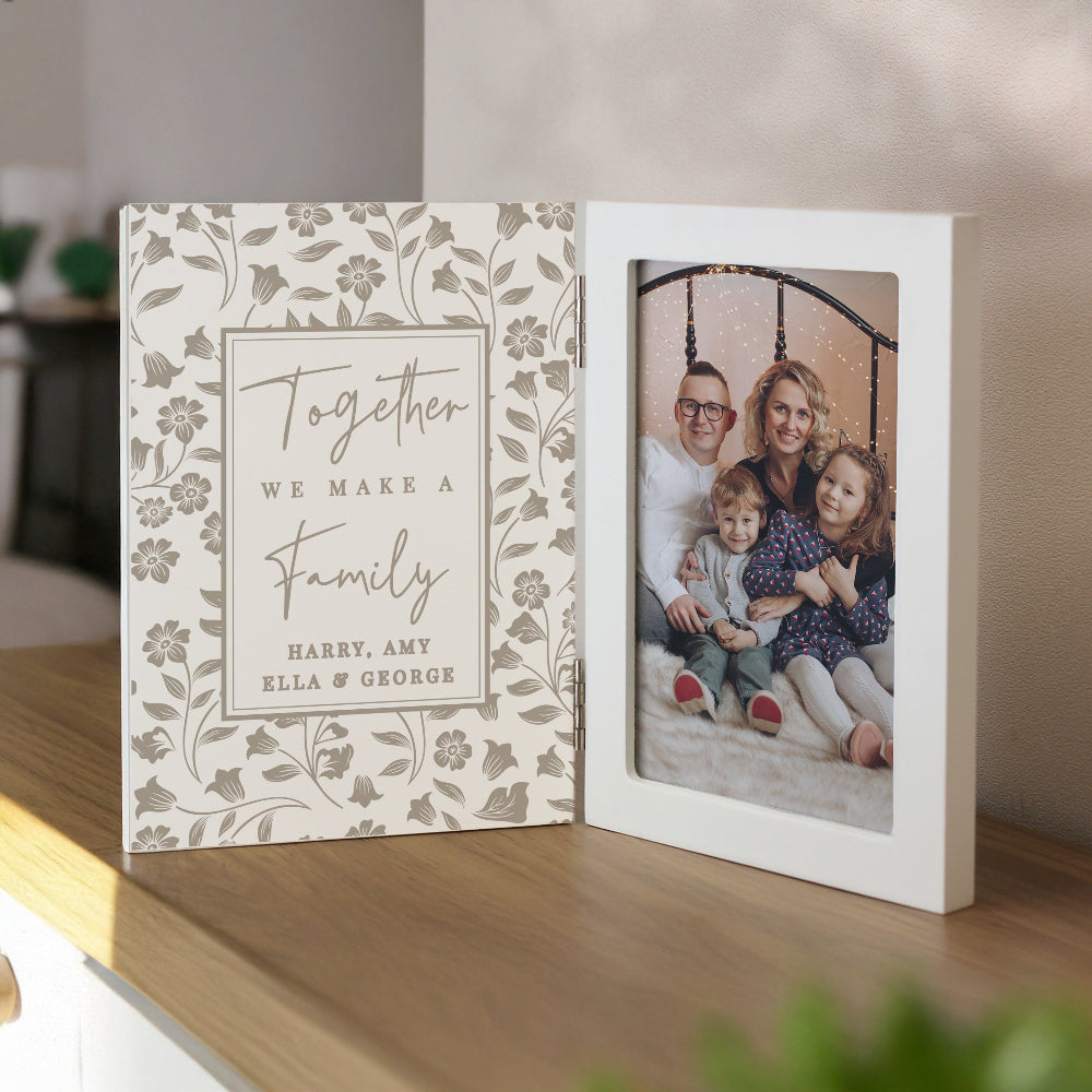 Personalized photo album with floral design and family photo on a wooden surface.