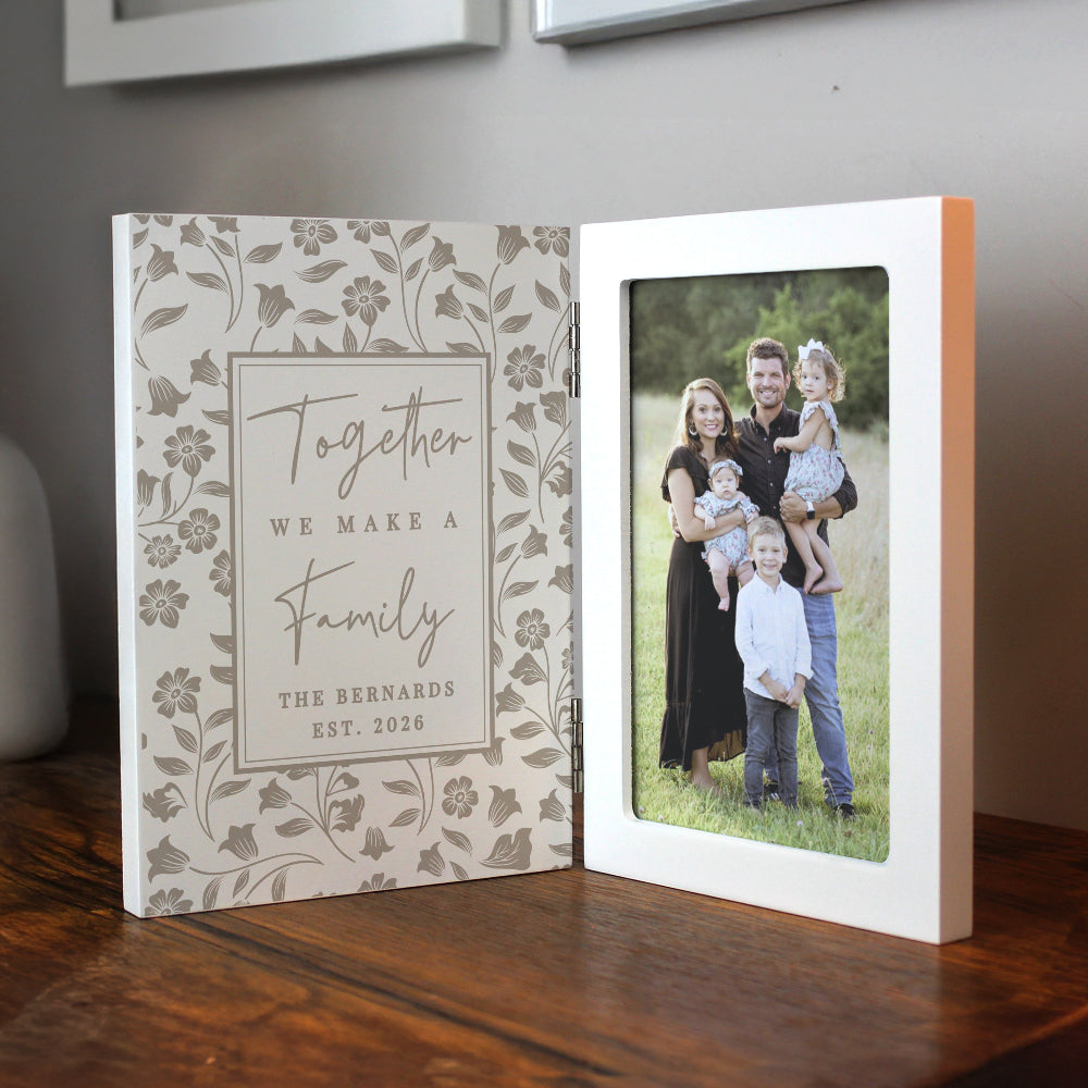 Personalized photo album with family photo and decorative cover on a wooden surface.