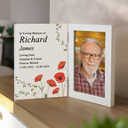 Memorial book with photo and text of an elderly man on a wooden surface.