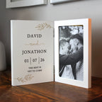 Personalized photo album with a black and white photo of two people and text on a wooden surface.