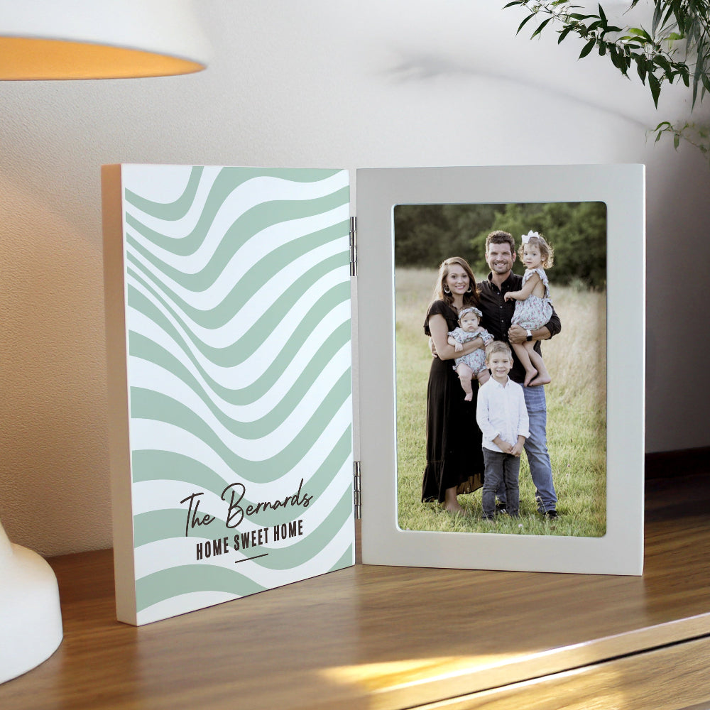 Open photo album with a family photo on a wooden surface